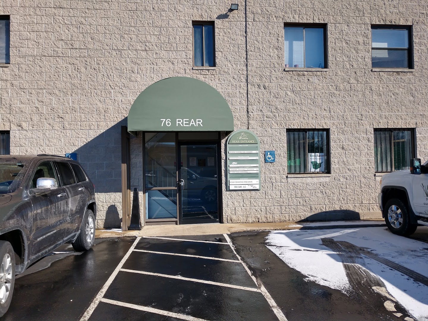 Four Seasons Firearms storefront under the green awning at 76 Rear Winn Street, Woburn